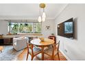 Bright dining area featuring a round table, modern lighting, and a large window offering natural light and views at 1175 N Emerson St # 103, Denver, CO 80218