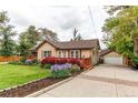 Charming single Gathering home with a detached garage, front porch, and landscaped yard at 7785 W 5Th Ave, Lakewood, CO 80226
