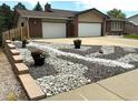 Beautiful home exterior showcasing a well-designed driveway, and decorative rock landscaping at 7784 Lewis St, Arvada, CO 80005