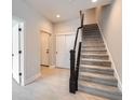 Bright entryway with stairs, light wood floors, and white doors at 2570 Josephine Way, Superior, CO 80027