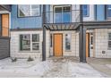 Orange door entrance to townhome with white stone exterior at 2570 Josephine Way, Superior, CO 80027