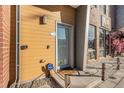 Close up of the entrance door, showing the door, sidelight, and welcome mat at 4258 Tennyson St # 104, Denver, CO 80212