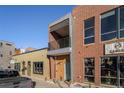 Brick building with a balcony and large windows for a storefront or commercial space at 4258 Tennyson St # 104, Denver, CO 80212