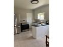 Well-lit kitchen features stainless steel appliances and white cabinets at 1237 Tamarac St, Denver, CO 80220