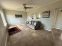 Bright living room featuring tile floors, a ceiling fan, and gray walls at 1237 Tamarac St, Denver, CO 80220