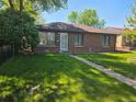 Charming brick home with a well-manicured lawn and mature trees in a desirable neighborhood at 2285 Ironton St, Aurora, CO 80010