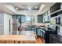 Bright kitchen featuring stainless steel appliances, modern cabinetry, and a kitchen island at 10806 W Evans Ave # 5, Lakewood, CO 80227