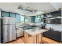Charming kitchen with modern appliances, ample cabinetry and kitchen island at 10806 W Evans Ave # 5, Lakewood, CO 80227