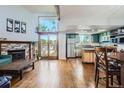 Open-concept living room with wood floors, fireplace, and stainless steel appliances at 10806 W Evans Ave # 5, Lakewood, CO 80227