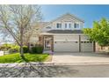 Charming two-story home featuring a three-car garage, well-kept lawn, and mature trees at 7506 Chipmunk Pl, Littleton, CO 80125