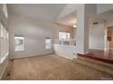 Bright living room featuring large windows and plush carpeting, ready for relaxation at 7506 Chipmunk Pl, Littleton, CO 80125