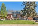 Charming brick home with a well-manicured lawn and inviting outdoor seating area on the patio at 6925 W 27Th Ave, Wheat Ridge, CO 80033