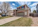 Two-story home with brick facade, a two-car garage and well maintained lawn at 5368 Creek Way, Parker, CO 80134