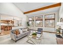 Bright living room with vaulted ceilings, exposed beams, and large windows with backyard views at 831 W Kettle Ave, Littleton, CO 80120