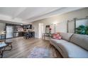 Living room with hardwood floors that seamlessly connects to the modern kitchen with stainless steel appliances at 33 N Corona St # 205, Denver, CO 80218