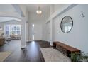 Bright foyer with dark wood floors, modern lighting, and a decorative mirror at 2347 Switch Grass Way, Castle Rock, CO 80109