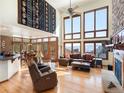 Bright living room with high ceilings, large windows showcasing scenic views, and hardwood floors at 76 Raven Ridge Rd, Idaho Springs, CO 80452