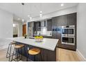 Modern kitchen featuring stainless steel appliances, gray cabinets, island and a stylish countertop at 250 Columbine St # 310, Denver, CO 80206