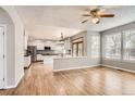 Sunlit open-concept living area with a bright kitchen, hardwood floors and great natural light at 2141 Weatherstone Cir, Highlands Ranch, CO 80126