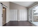 Bedroom featuring closet space, hardwood floors, and glass sliding door at 7683 S Steele St, Centennial, CO 80122