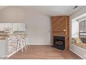 Open-concept living area features a wood-burning fireplace, kitchen bar and a cozy window seat at 7683 S Steele St, Centennial, CO 80122