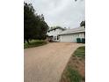 The extended driveway, accented by a manicured yard, leads to a two car garage at 3566 E Fair Pl, Centennial, CO 80121