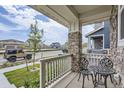 Cozy front porch with decorative chairs and a view of the peaceful neighborhood at 6233 N Liverpool St, Aurora, CO 80019