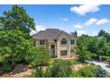 Lovely two-story home surrounded by mature trees and lush landscaping, offering a serene and private setting at 1564 S Uinta Way, Denver, CO 80231