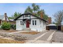 Exterior of house shows inviting curb appeal, side yard, and detached garage with driveway at 1736 Grove St, Denver, CO 80204