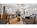 Bright living room featuring hardwood floors, ample natural light, and a decorative stone fireplace at 1736 Grove St, Denver, CO 80204