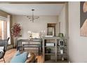 Open-concept dining room with modern lighting and stylish furniture at 3725 Federal Blvd, Denver, CO 80211