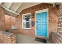 Close-up view of a home's inviting blue front door and brick facade at 3725 Federal Blvd, Denver, CO 80211