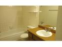 Tiled bathroom with a tub/shower combination, toilet, and single sink vanity at 14806 E 2Nd Ave Ave # 105G, Aurora, CO 80011