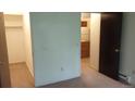 Carpeted bedroom with neutral walls, closet, and views to the kitchen at 14806 E 2Nd Ave Ave # 105G, Aurora, CO 80011