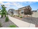 Well-maintained home exterior with lush landscaping and a welcoming sidewalk at 3934 N Quatar Ct, Aurora, CO 80019