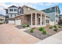 Inviting home exterior showcasing stone accents, manicured landscaping, and a covered porch at 3934 N Quatar Ct, Aurora, CO 80019