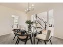 Elegant dining room with a modern glass table set, stylish decor, and view of open floor plan at 3549 Mallard Dr, Highlands Ranch, CO 80126
