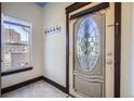 Entryway with decorative glass door, marble flooring and a transom window at 820 Kimbark St # B, Longmont, CO 80501