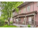 Charming exterior featuring a covered front porch, mature trees, and a well-maintained lawn at 820 Kimbark St # B, Longmont, CO 80501