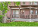 Cozy covered porch featuring seating, a lattice base, and views of the green lawn at 820 Kimbark St # B, Longmont, CO 80501