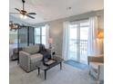 Comfortable living room with vaulted ceiling, ceiling fan, and access to a balcony at 9640 W Chatfield Ave # A, Littleton, CO 80128