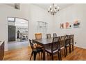 Open dining area with a long table, chandelier, and access to the kitchen at 915 26Th St, Denver, CO 80205
