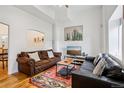 Bright living room featuring hardwood floors, two sofas, and a colorful area rug at 915 26Th St, Denver, CO 80205