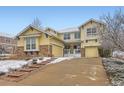Charming two-story home with a welcoming stone-accented facade and an attached two-car garage at 8385 Briar Trace Dr, Castle Pines, CO 80108
