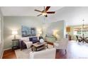 Bright living room with hardwood floors, ceiling fan, and modern furnishings at 4164 E 135Th Pl, Thornton, CO 80241