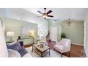 Bright living room with hardwood floors, ceiling fan, and modern furnishings at 4164 E 135Th Pl, Thornton, CO 80241