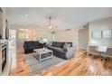 Bright living room features hardwood floors, comfortable seating, and a cozy fireplace at 1367 Teller St, Lakewood, CO 80214