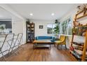 Sunlit living area showcasing hardwood floors, comfortable seating, and an inviting atmosphere at 2870 Pontiac St, Denver, CO 80207
