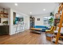 Bright living room featuring hardwood floors, natural light, and an open layout, adjacent to the kitchen at 2870 Pontiac St, Denver, CO 80207