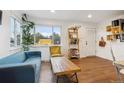 Bright living room with hardwood floors, a large window, comfortable seating, and stylish decor at 2870 Pontiac St, Denver, CO 80207